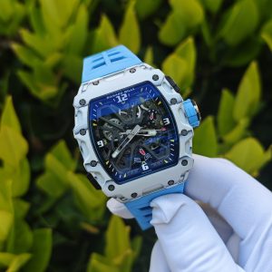 The Richard Mille RM35-03, in white, is equipped with a customized Parmigiani movement. All functions are authentic and operational. It features a deployable butterfly rotor, a customized imported carbon fiber case, and a blue natural rubber strap. - Image 3