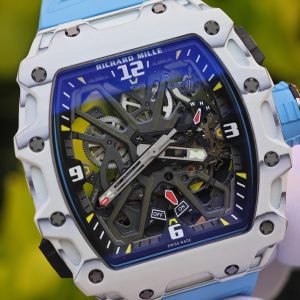 The Richard Mille RM35-03, in white, is equipped with a customized Parmigiani movement. All functions are authentic and operational. It features a deployable butterfly rotor, a customized imported carbon fiber case, and a blue natural rubber strap. - Image 9